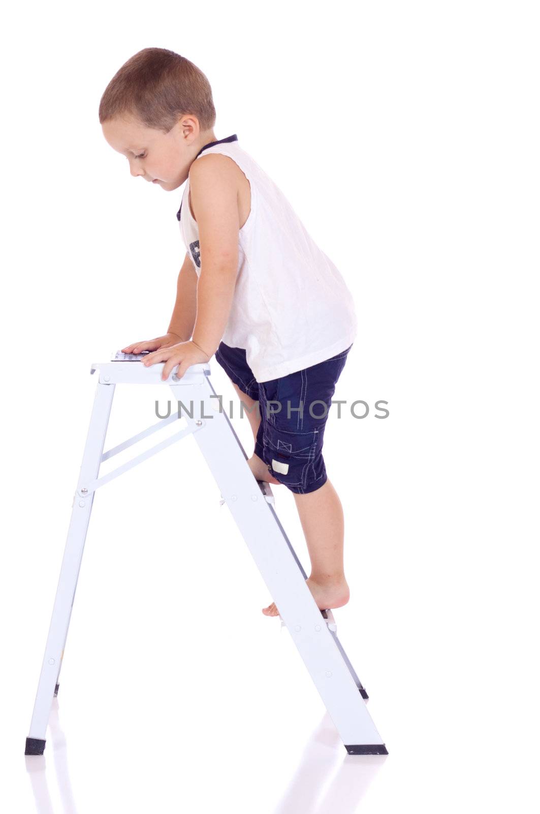 Cute little boy climbing on a stepladder