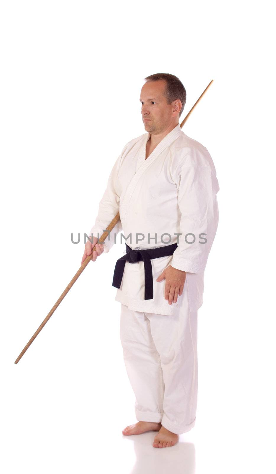 Man in karate-gi with a bo (staff) sai in his hands