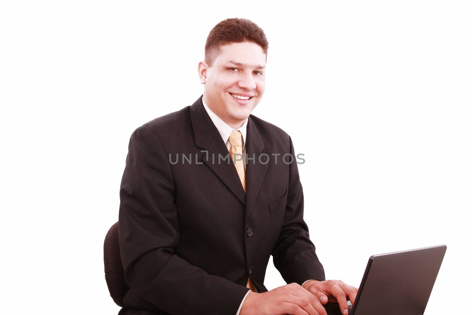 Portrait of businessman in front of laptop computer