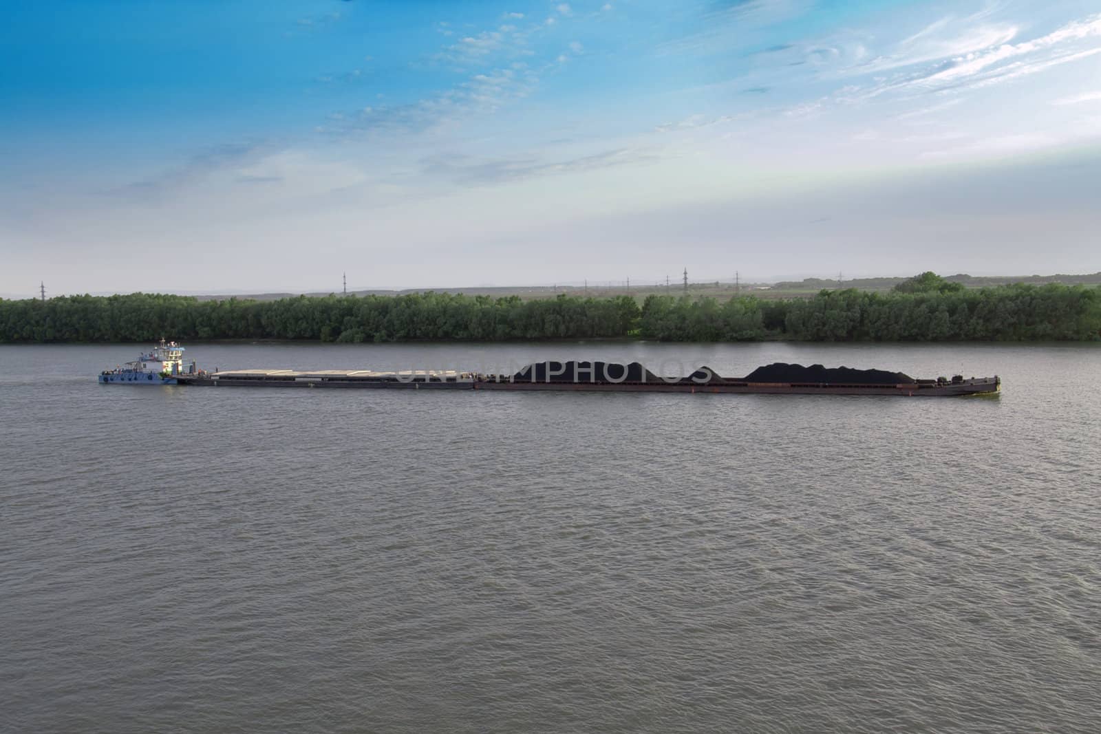 coal of barge on Mississippi by Lexxizm