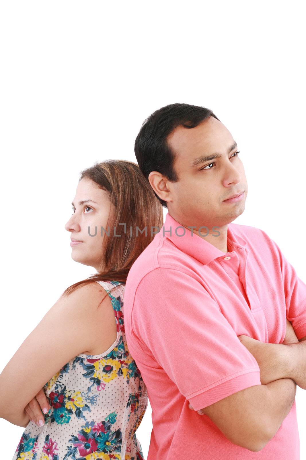 Young couple standing back to back having relationship difficulties on white background