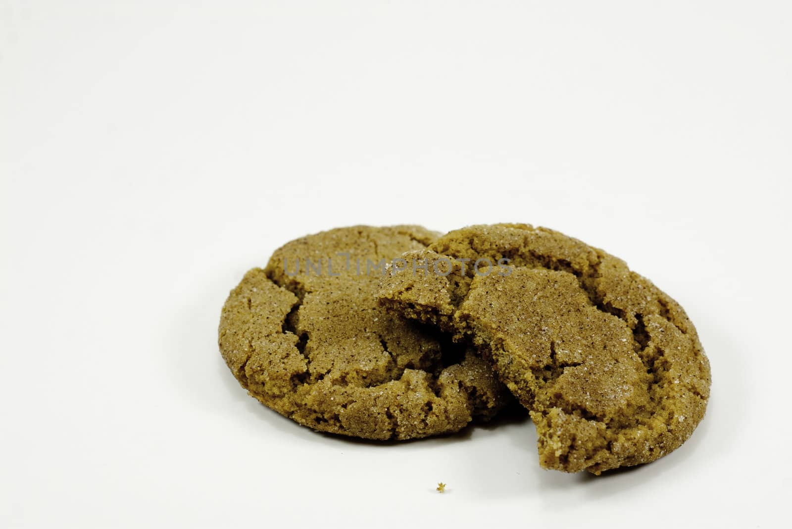 two ginger snap cookies with bite