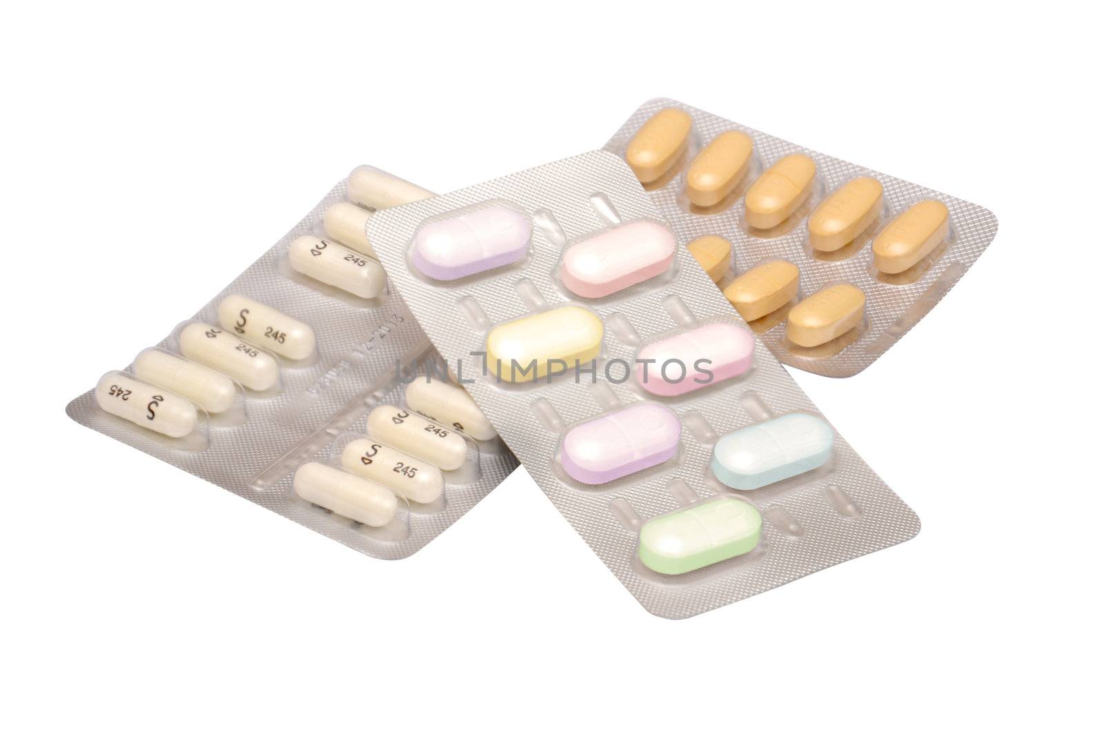 Multicolored medicine pills on the white background 