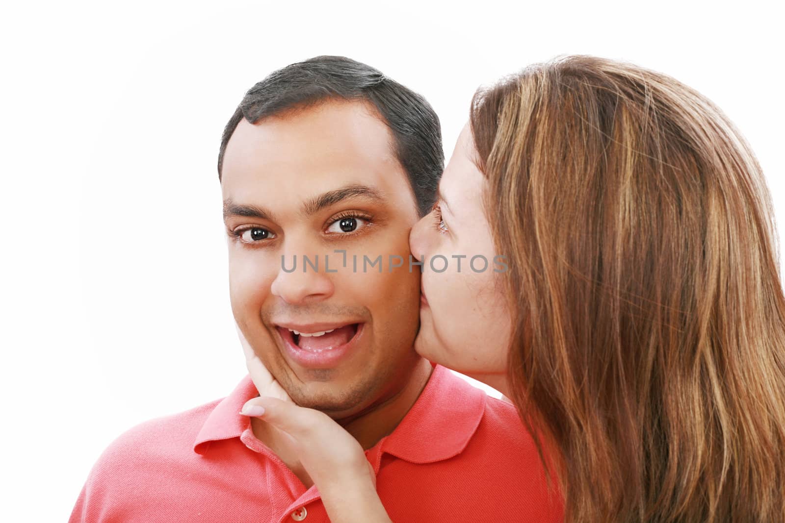 Young woman kissing her surprised boyfriend, isolated on white by dacasdo