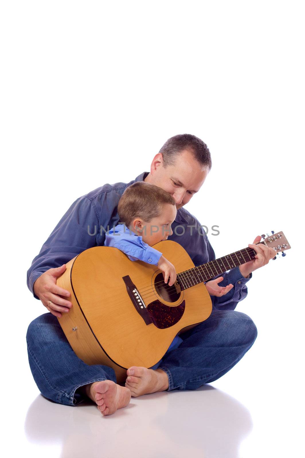 Father and son holding a guitar