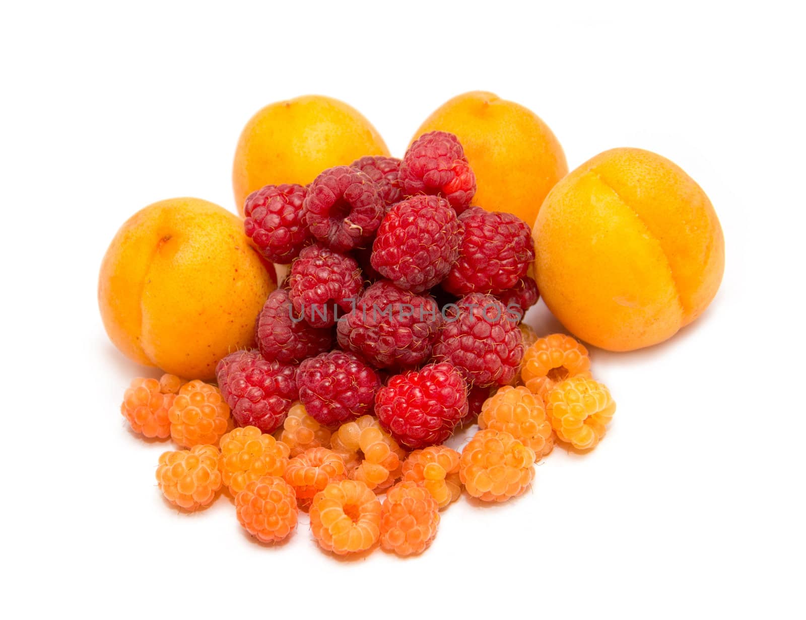 Heap ripe apricot with raspberry on white background
