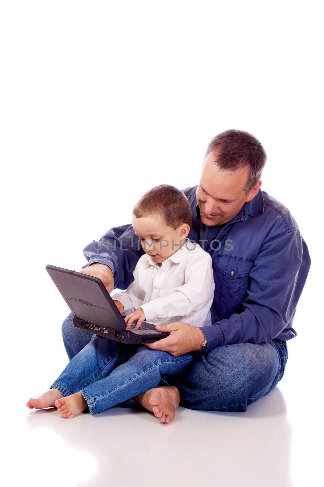Father and son sitting with a laptop
