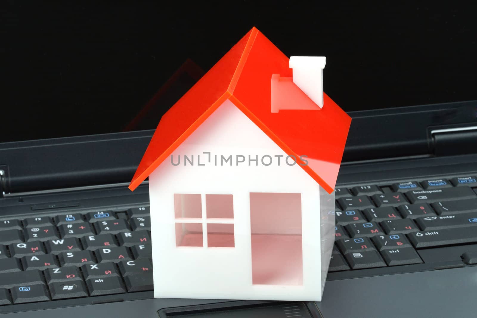 House model on laptop. Real property or insurance concept 