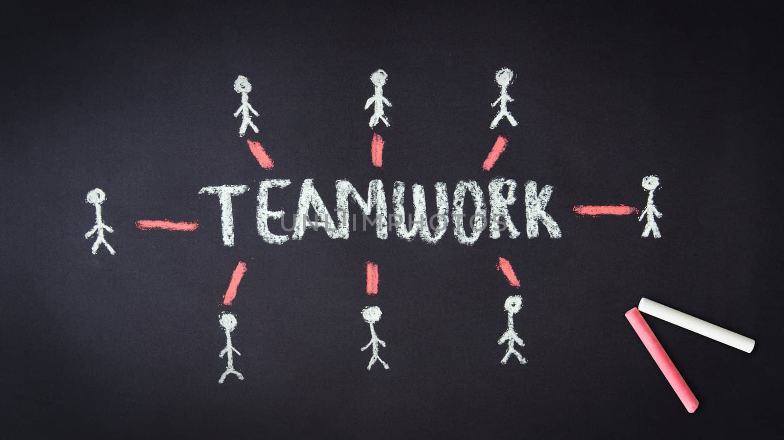 Chalk drawing of a Teamwork illustration on dark background.