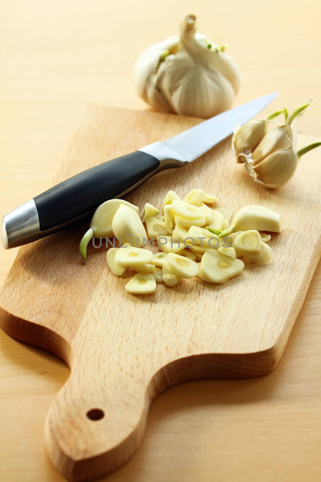 chopped garlic on a wooden board, selective focus