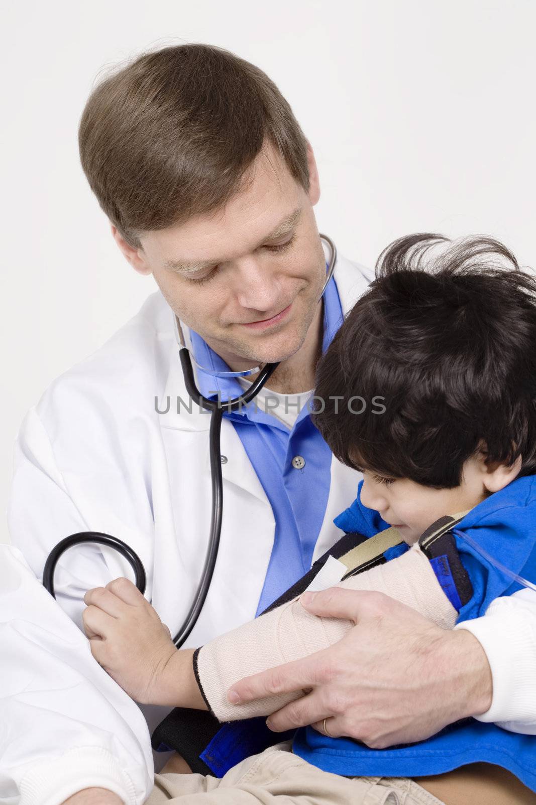 Male doctor interacting with  disabled  toddler patient on lap by jarenwicklund