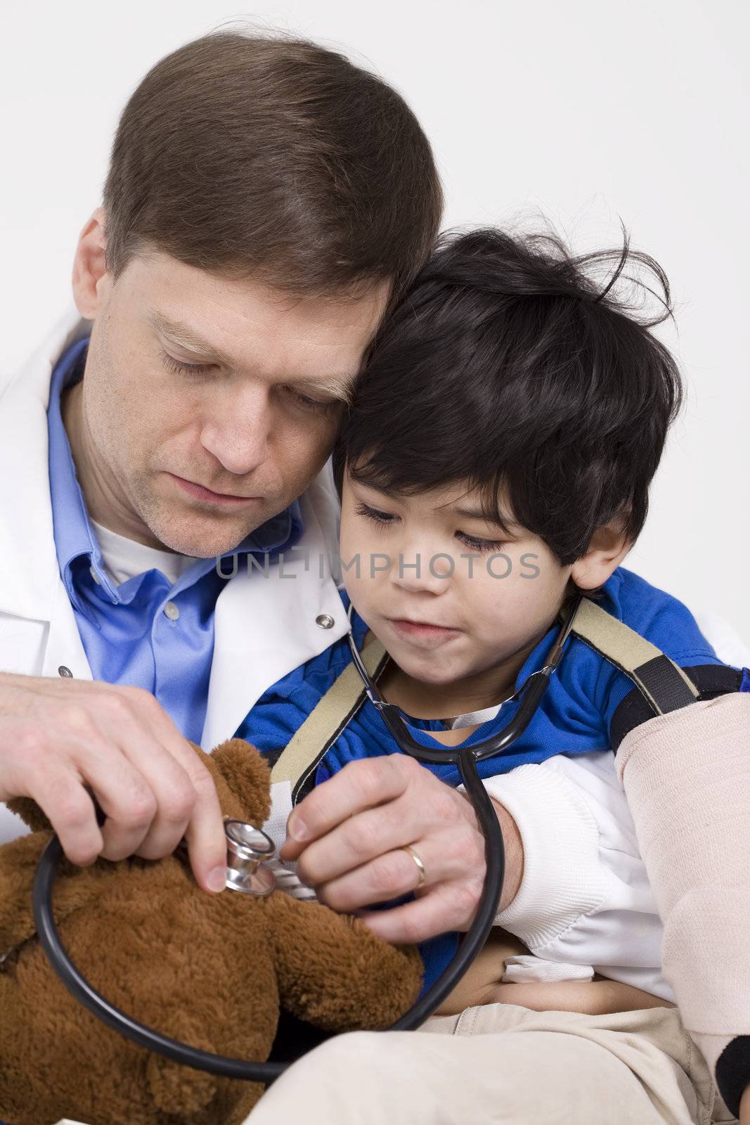 Male doctor interacting with disabled  toddler patient on lap by jarenwicklund