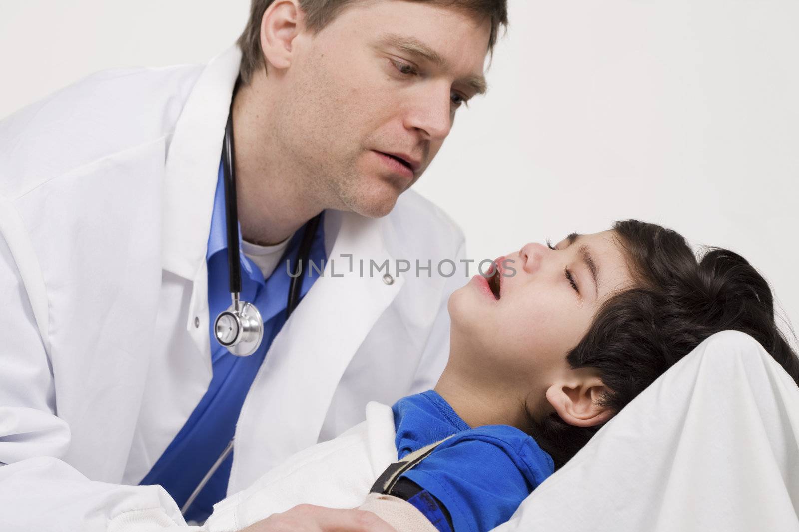 Male doctor comforting disabled  toddler patient. Child is five years old by jarenwicklund