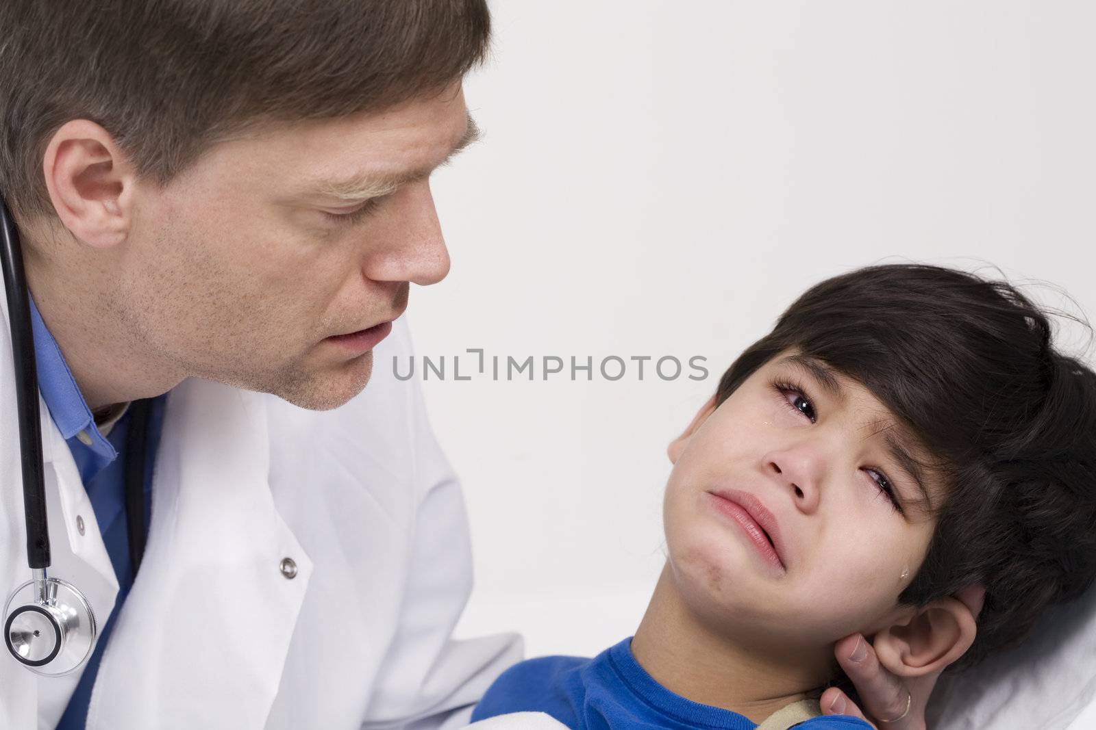 Male doctor comforting disabled  toddler patient. Child is five years old by jarenwicklund