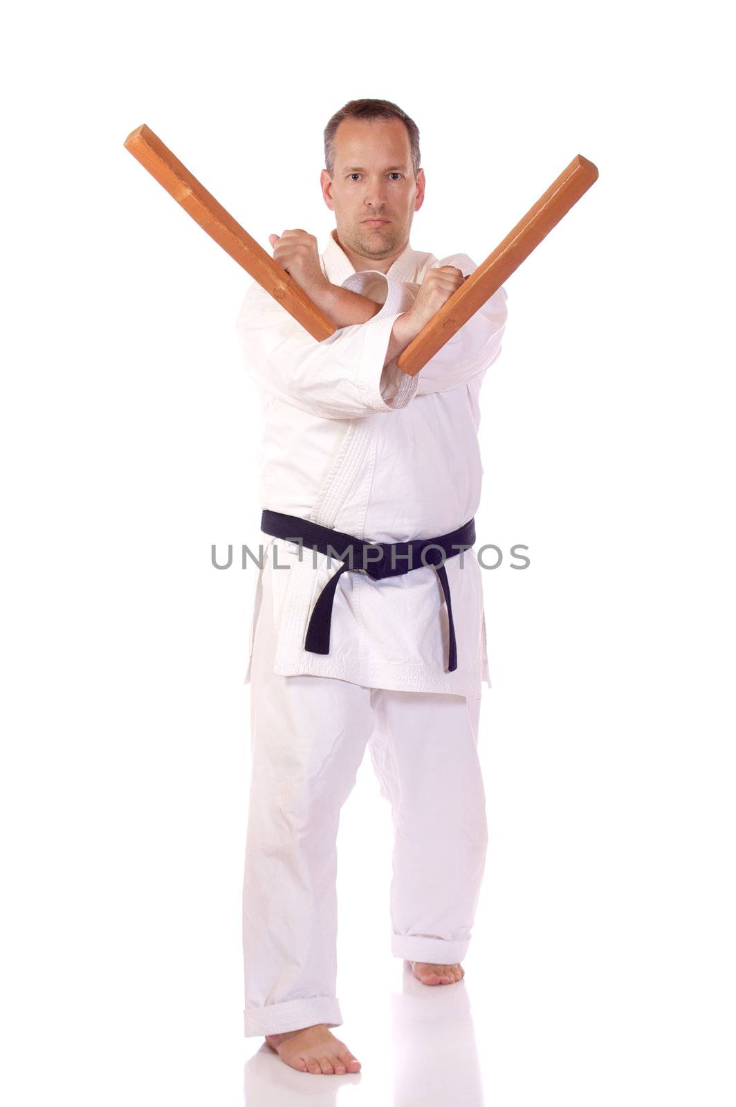 Man in karate-gi holding a pair of tonfa