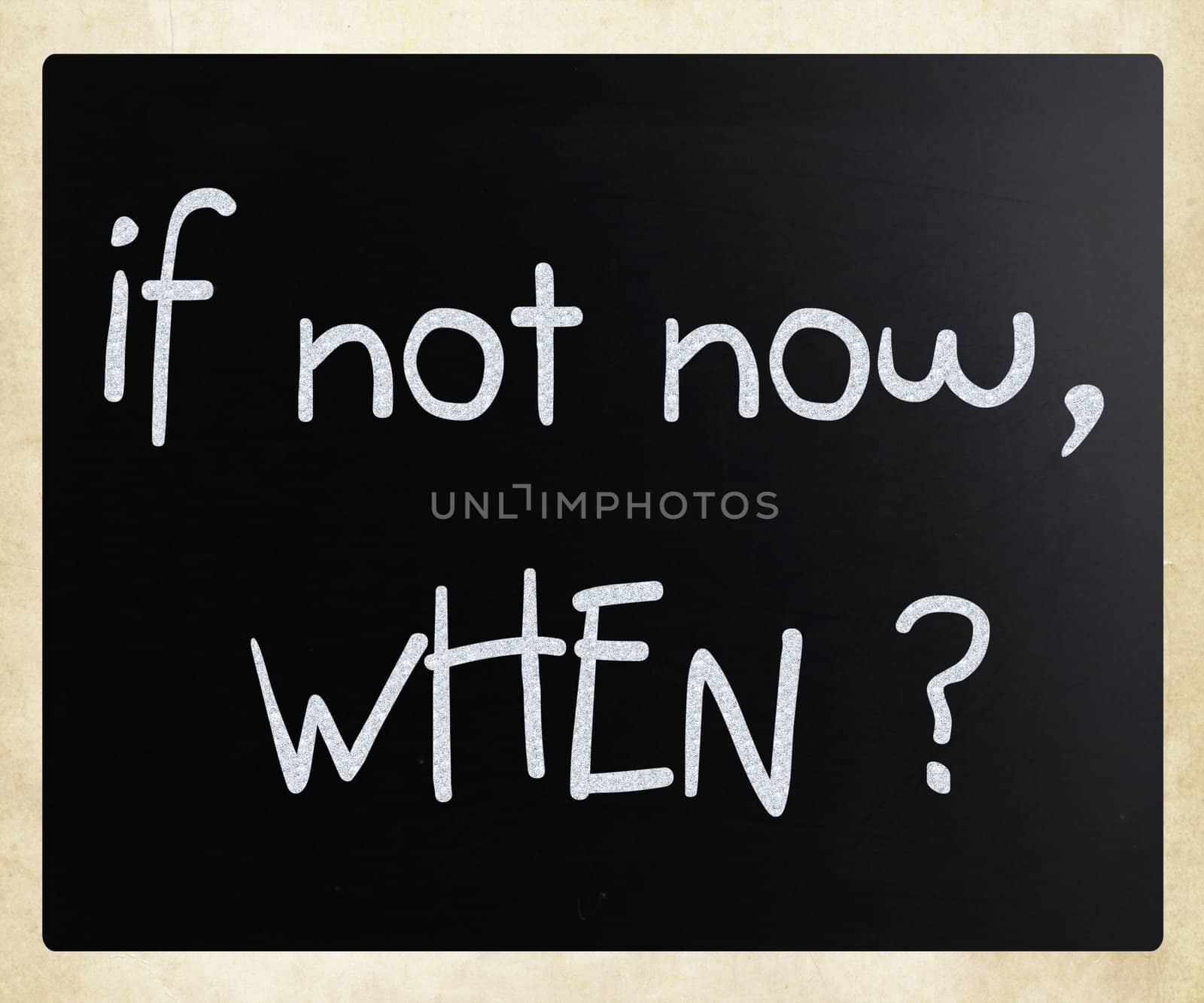 "If not now, when?" handwritten with white chalk on a blackboard