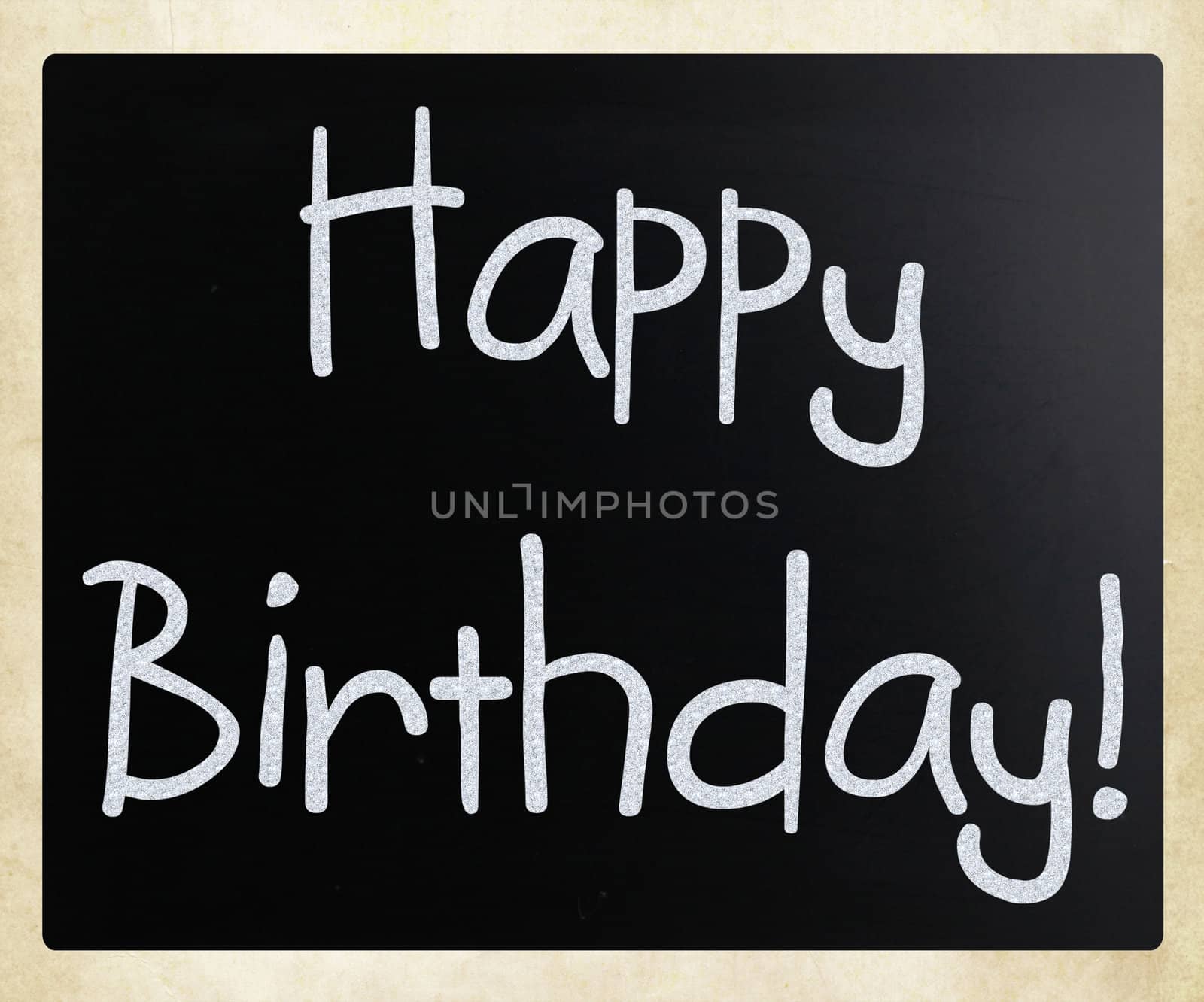 "Happy Birthday" handwritten with white chalk on a blackboard