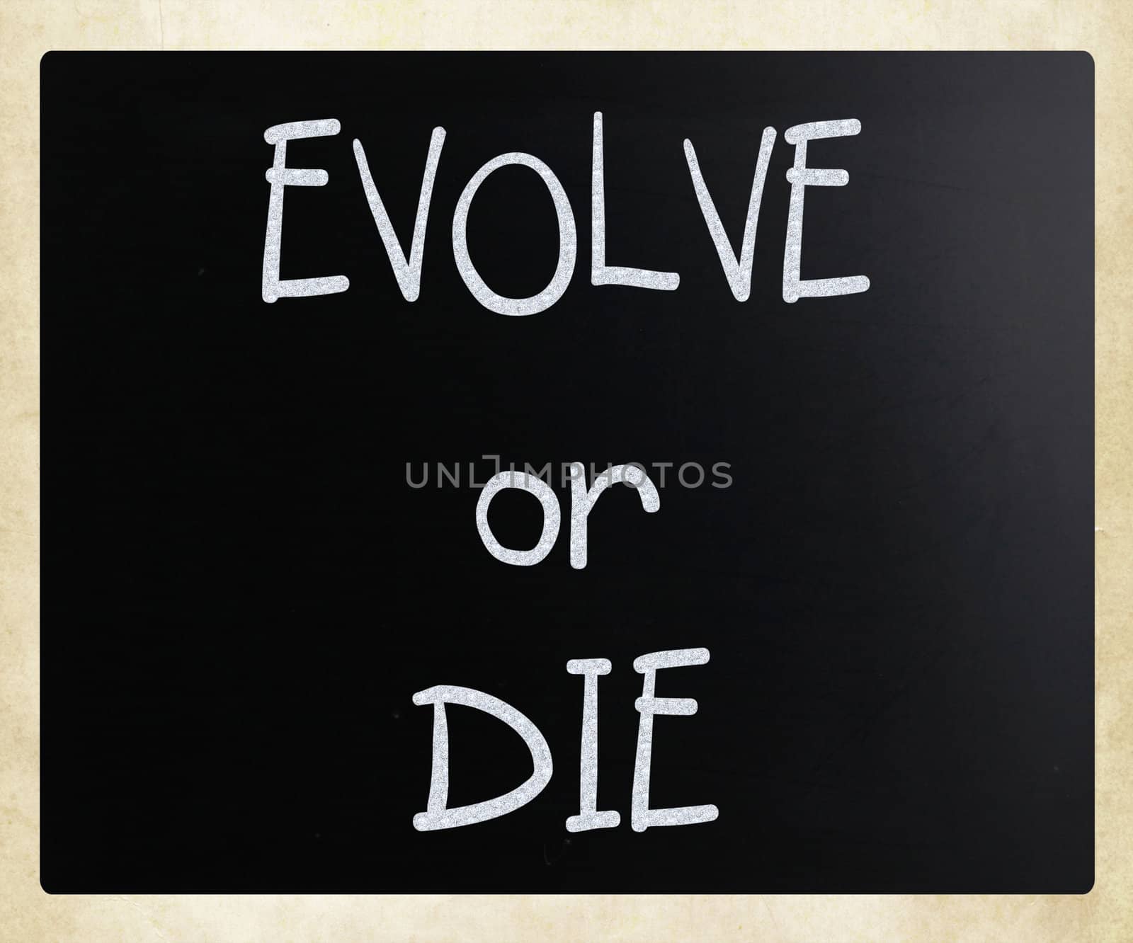 "Evolve or Die" handwritten with white chalk on a blackboard