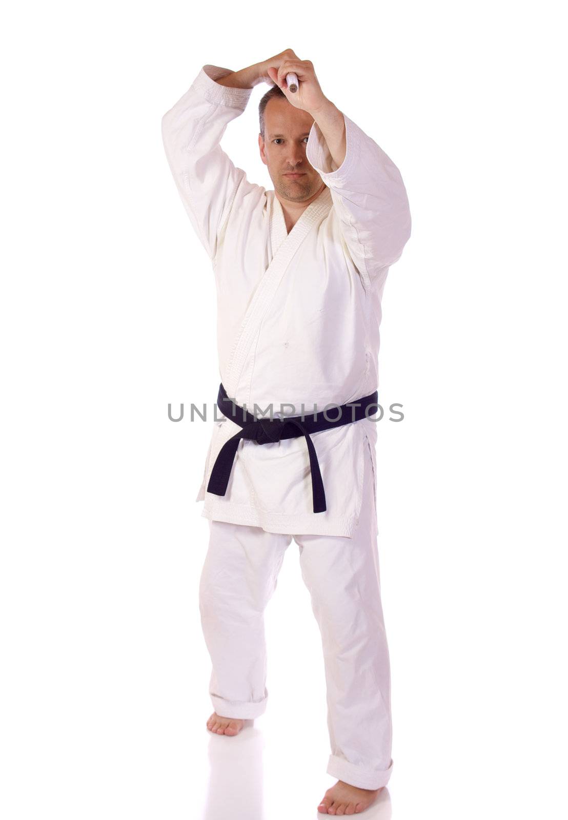 Man in karate-gi holding a bo staff