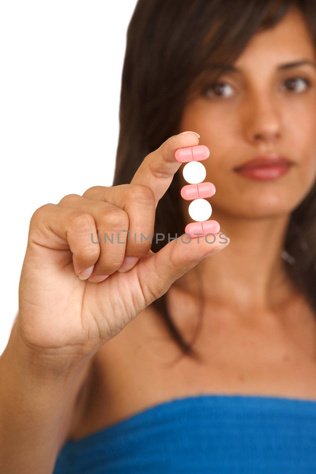 Young woman holding pills, isolated on white