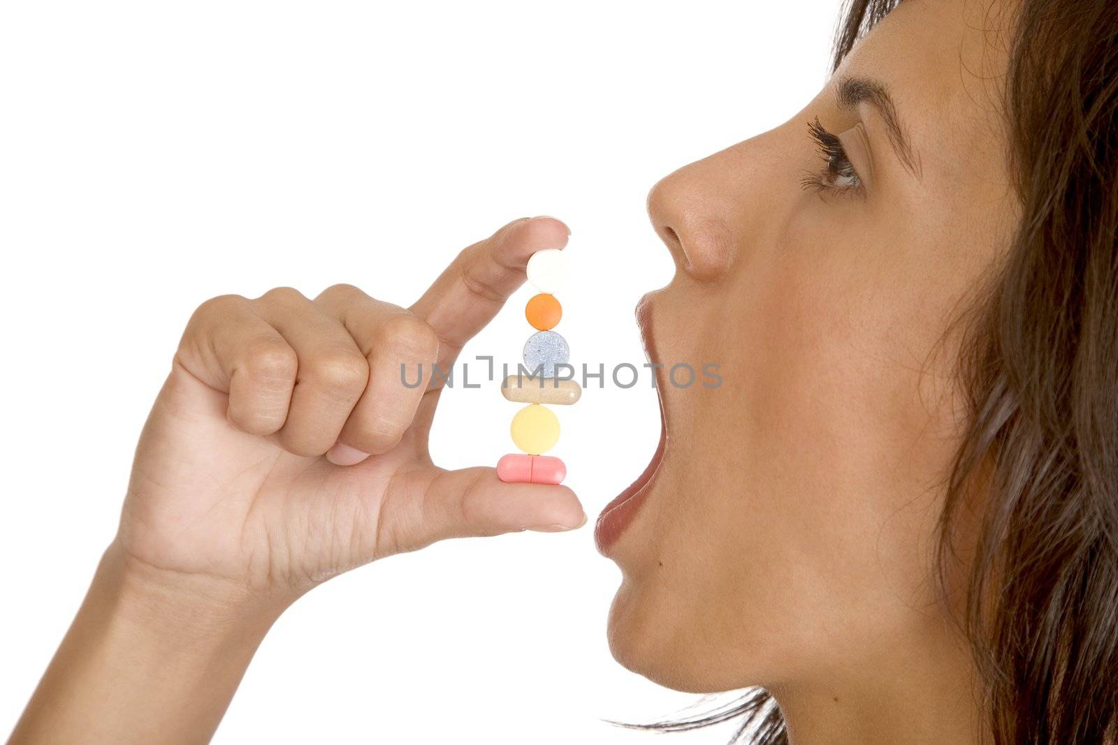 young women pops a pill into her mouth by VictorO