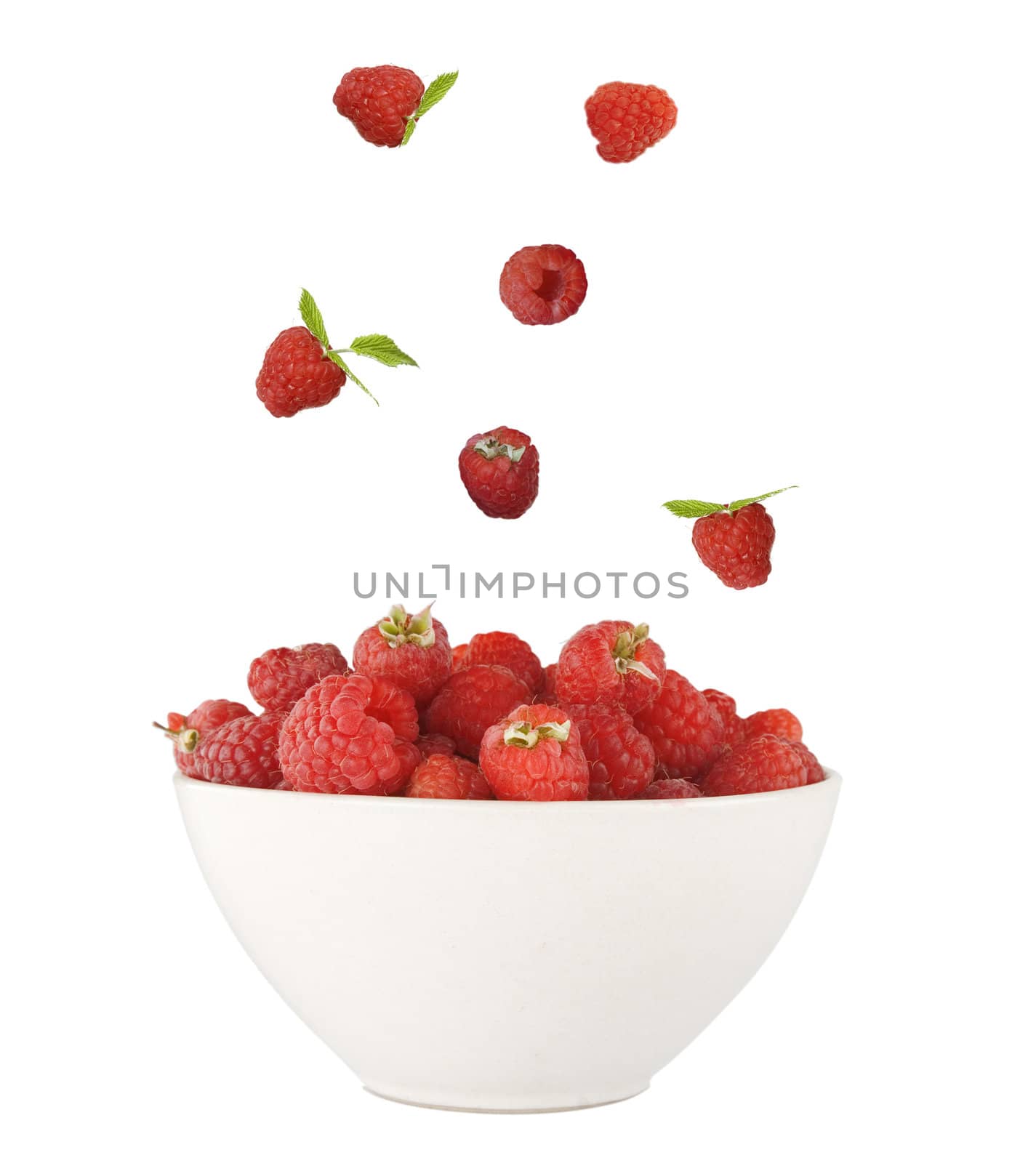 fresh red raspberries falling isolated on white background 