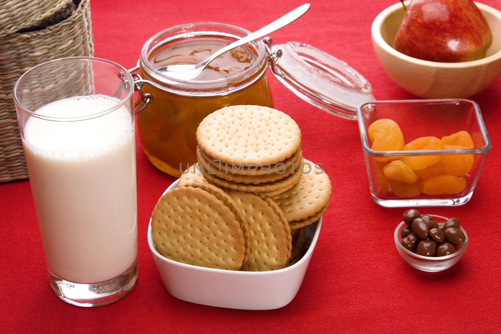 Delicious breakfast foods over red fabric background