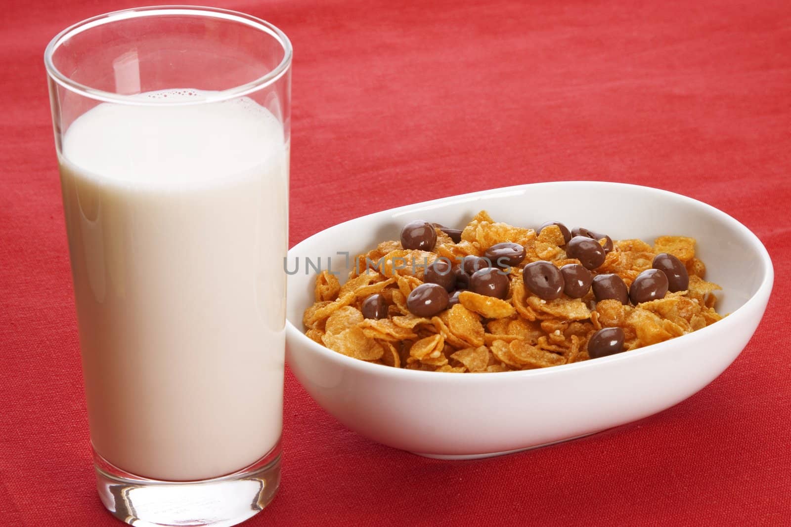 Delicious breakfast foods over red fabric background