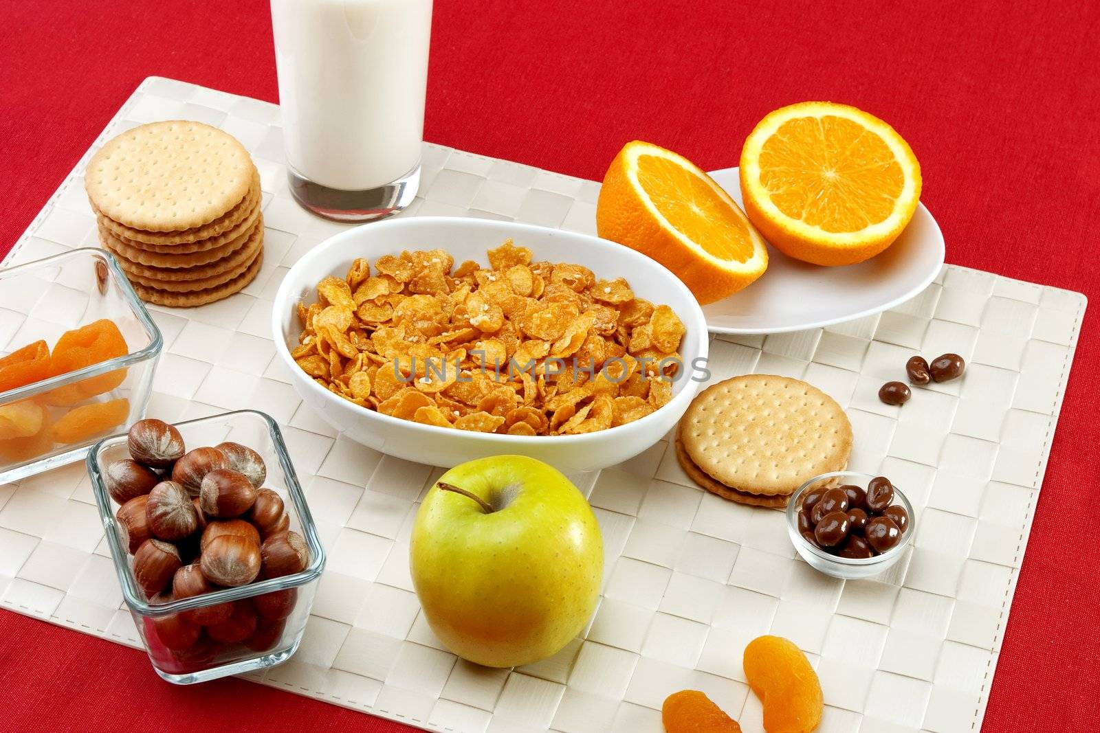 Delicious breakfast foods over red fabric background