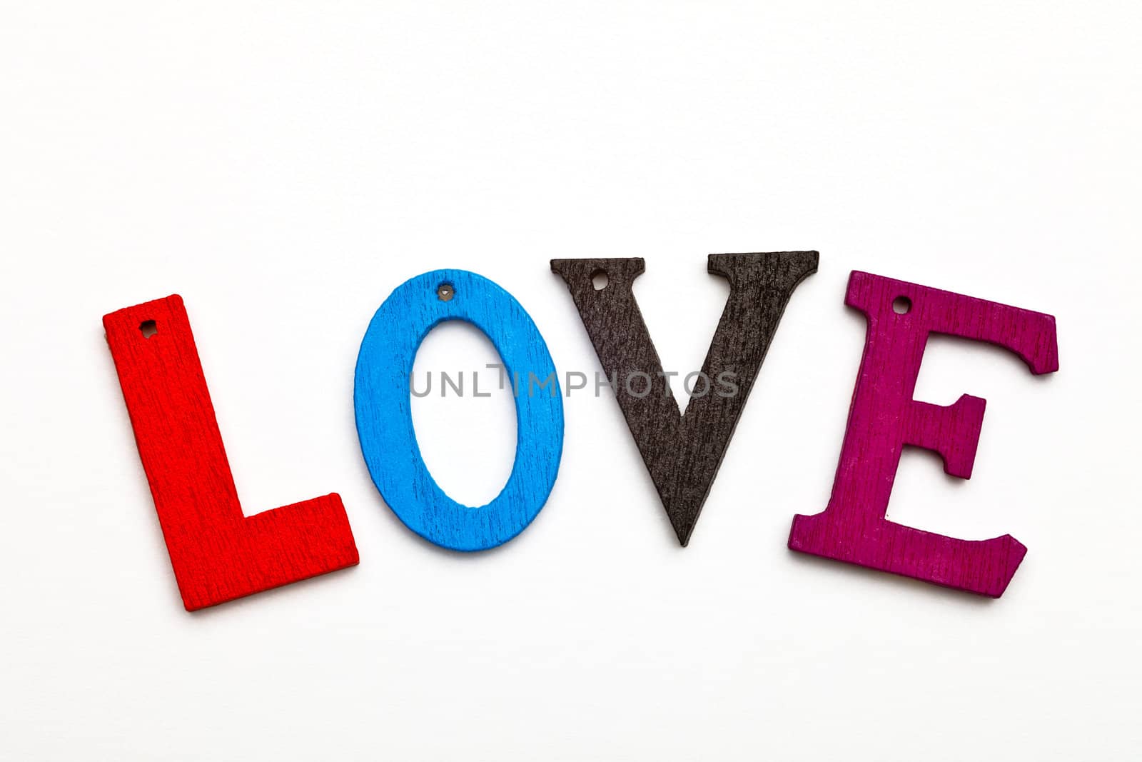 love word formed with colorful letter on neutral background