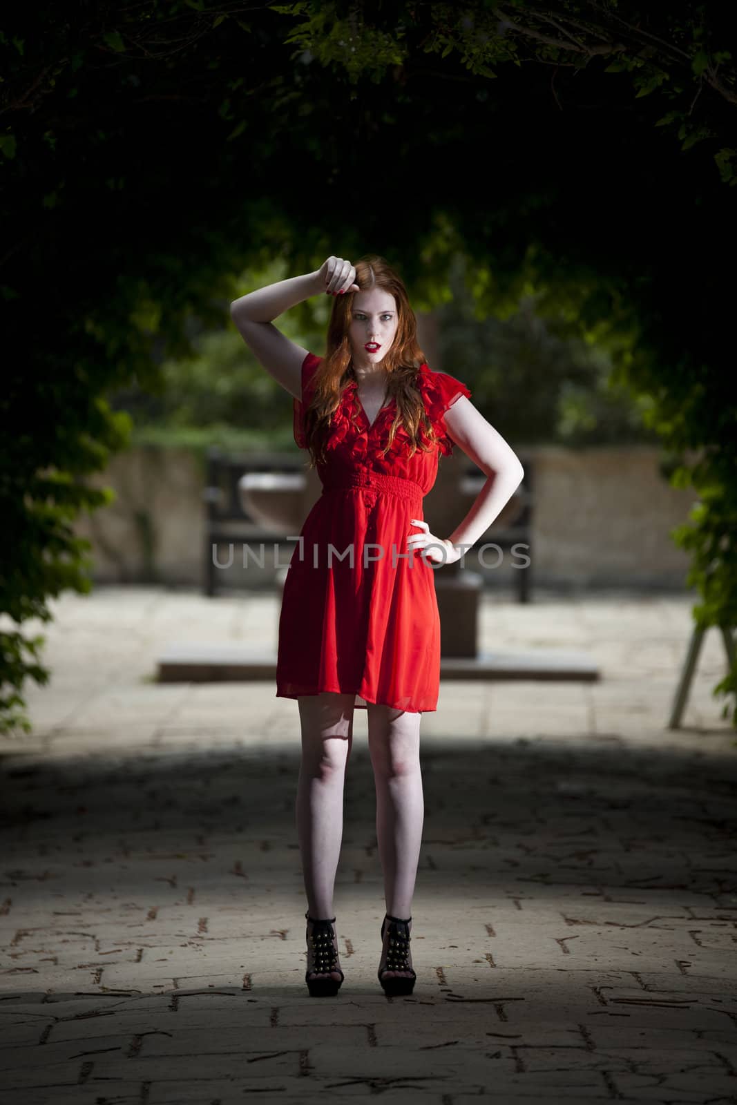 Young woman in red dress looking direct at viewer