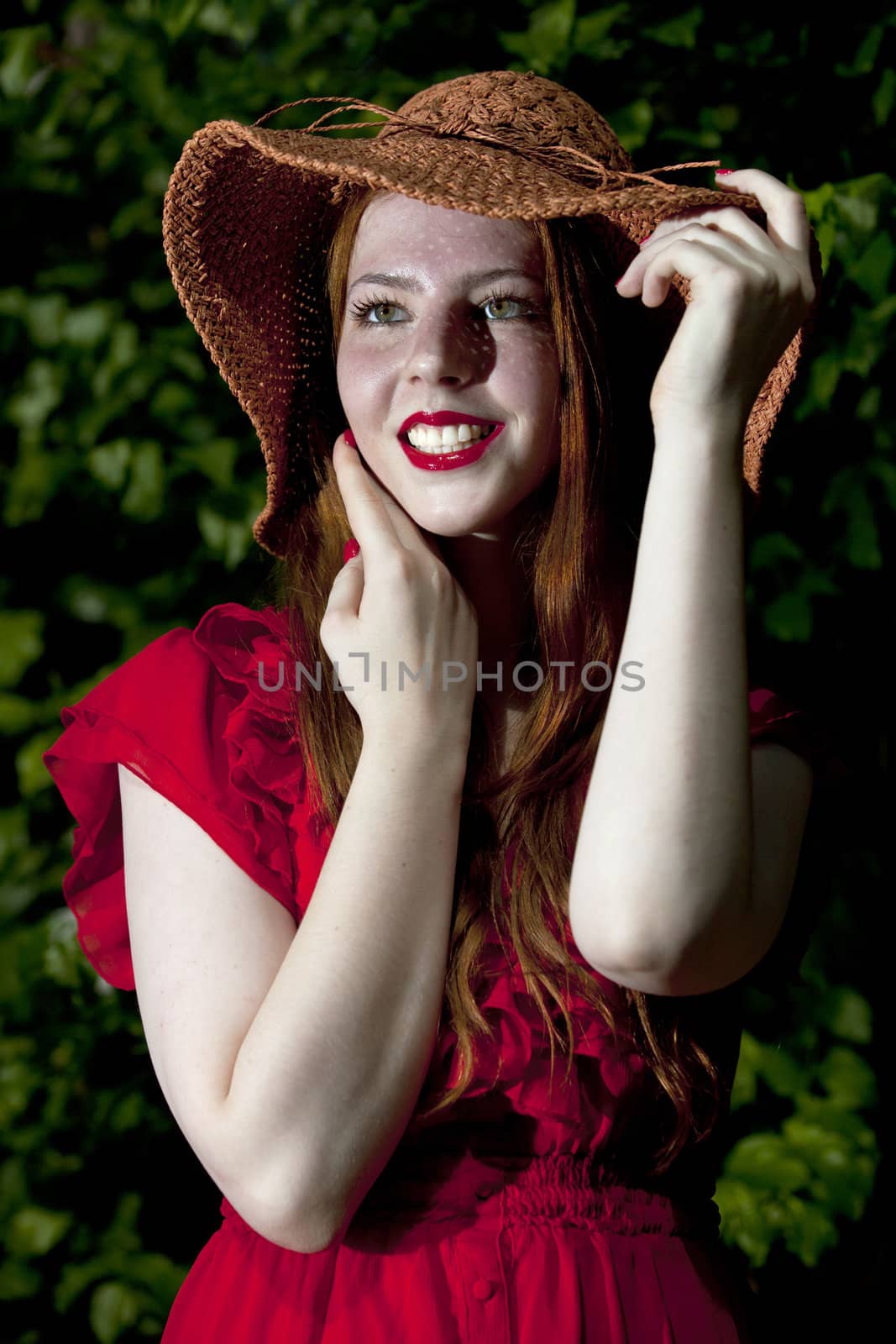 Young and happy woman wearing a hat