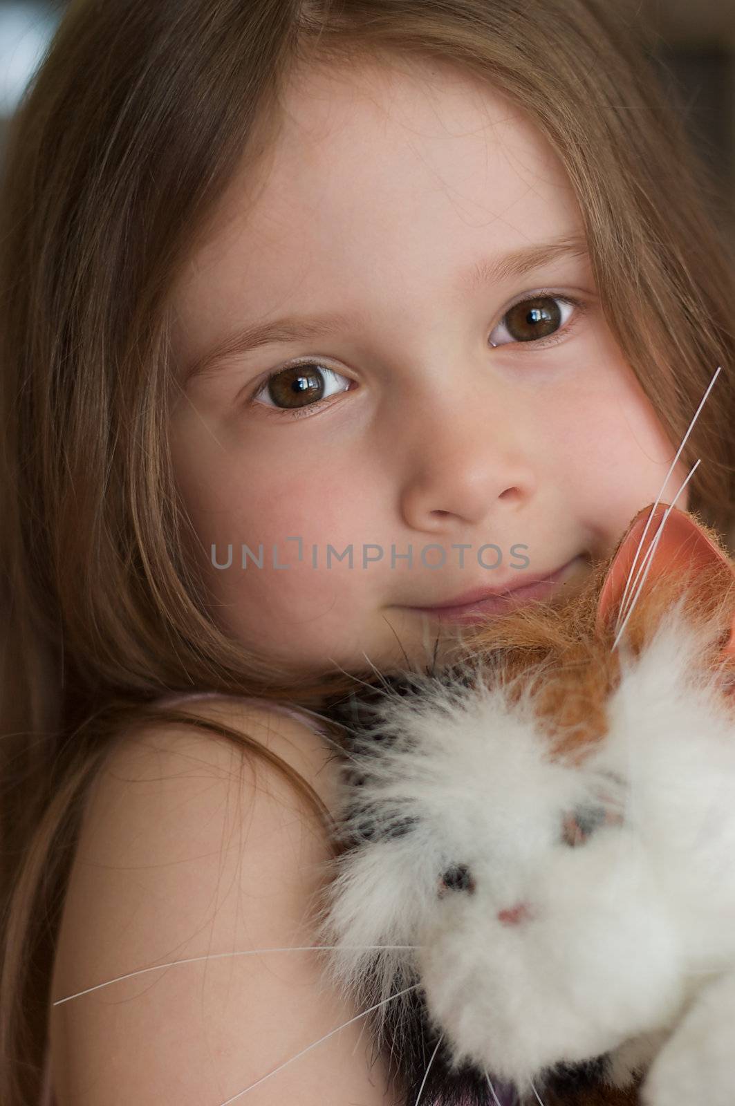 Dreamy little girl with a toy cat