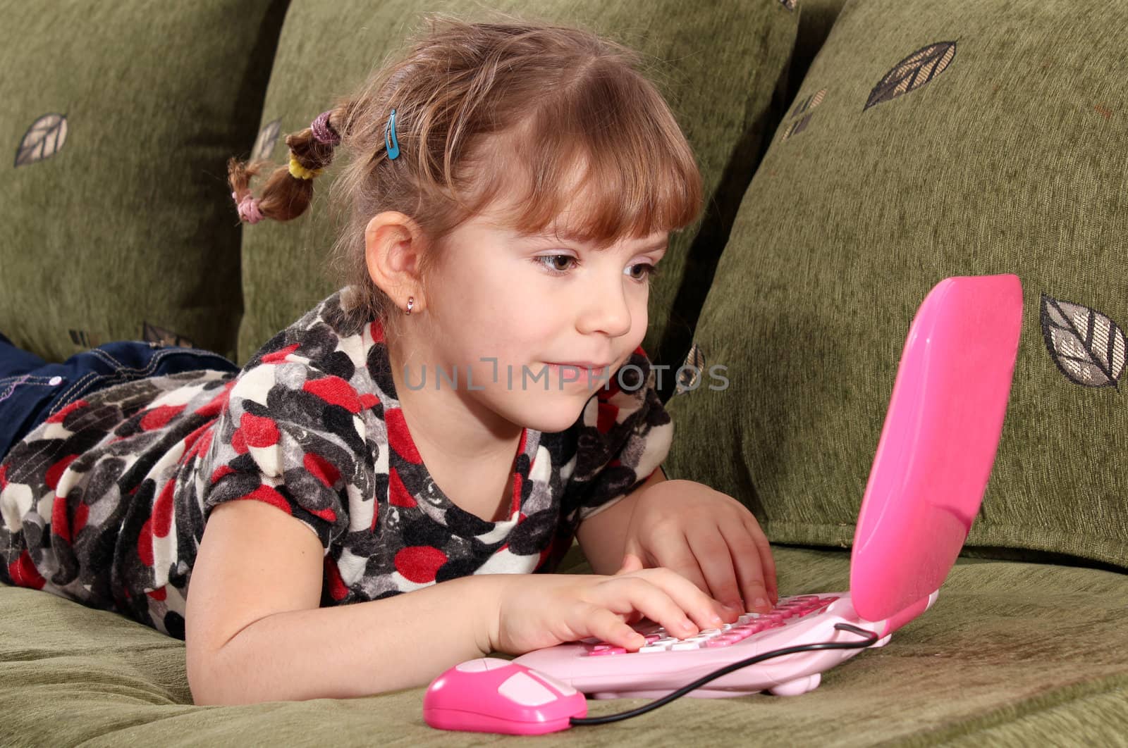 little girl typing on laptop