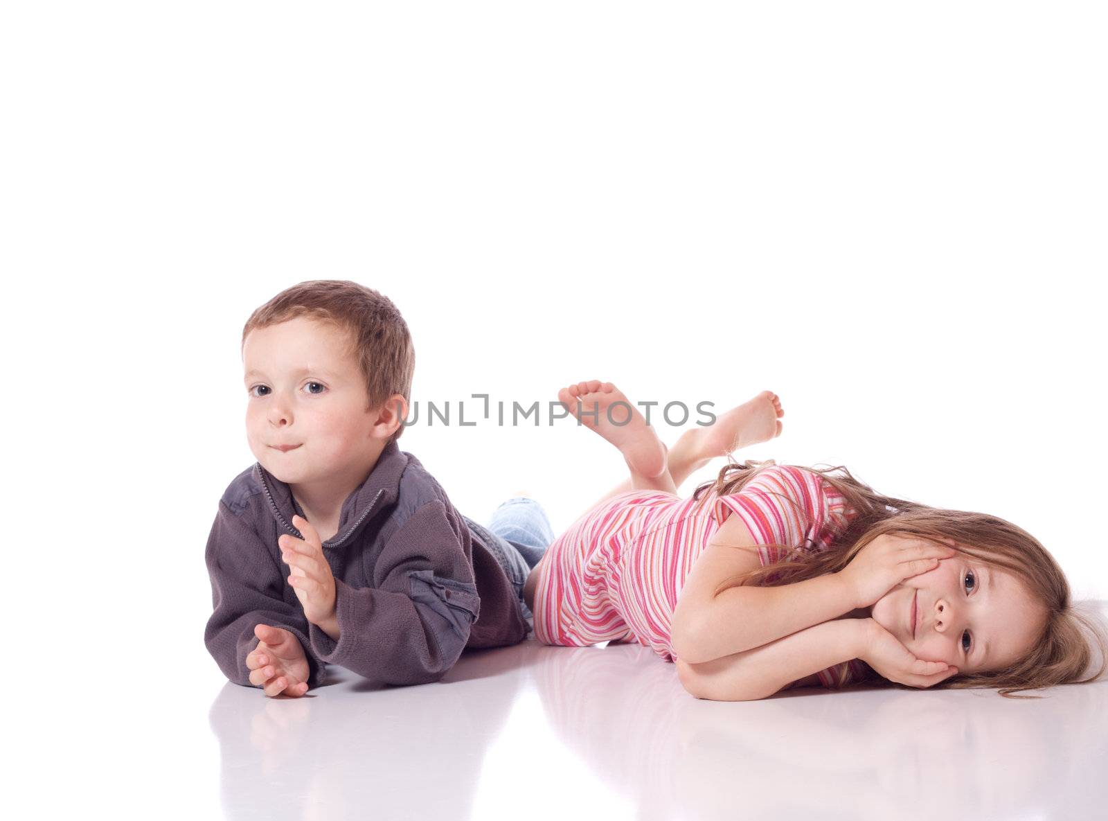 Cute brother and sister laying on their stomach