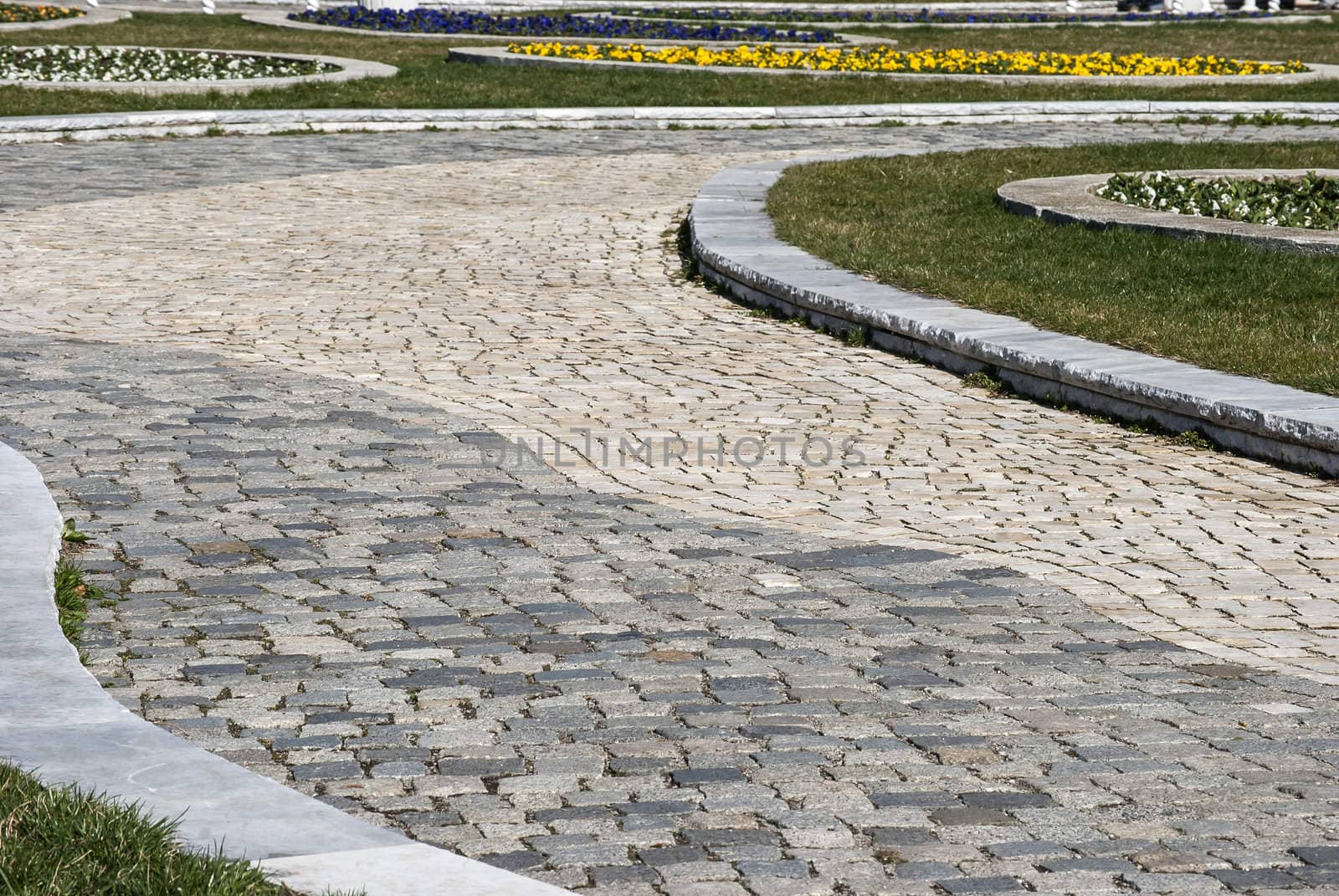 Stone paved park alley closeup as background