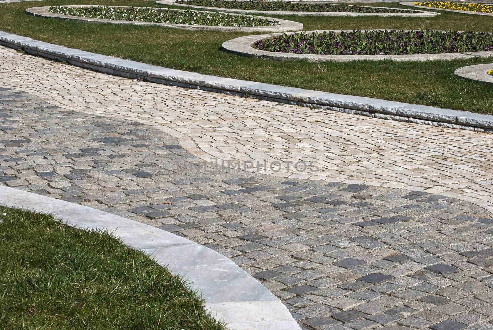 Stone paved park alley closeup as background