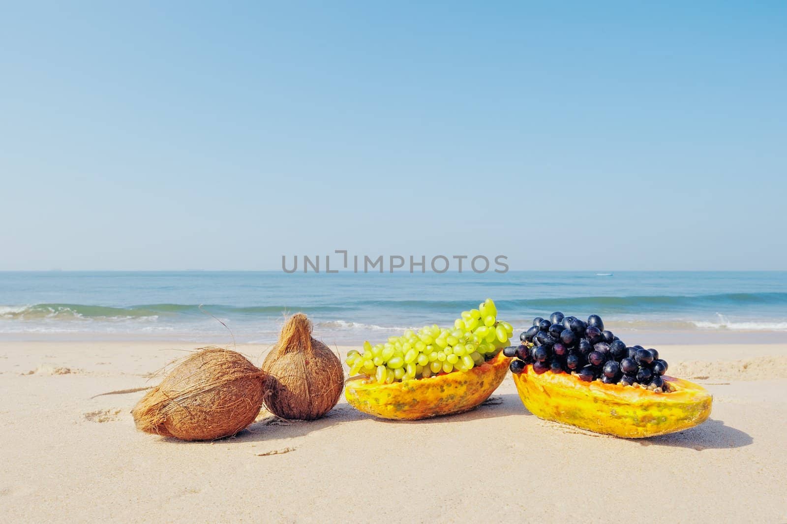 Papaya, coconut and grapes on the seacoast