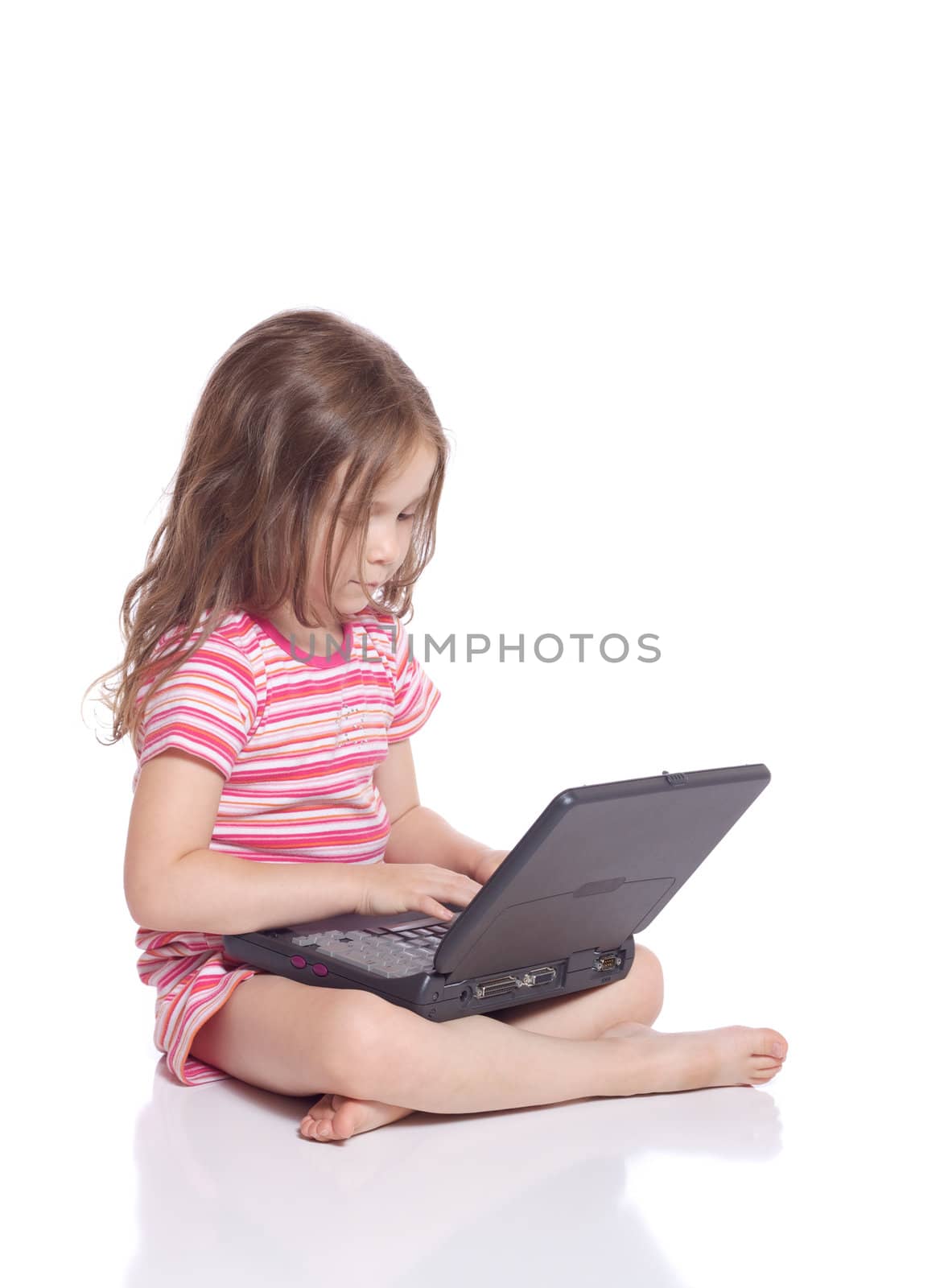Cute little girl siting with a laptop