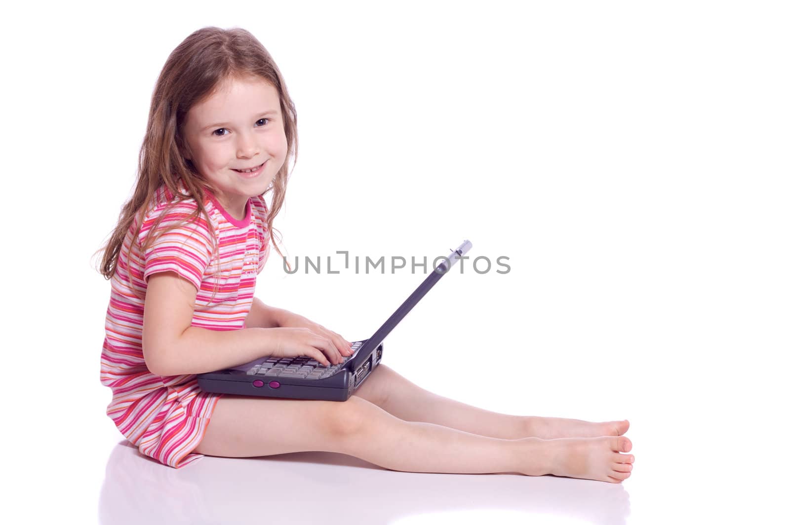 Cute little girl sitting with a laptop