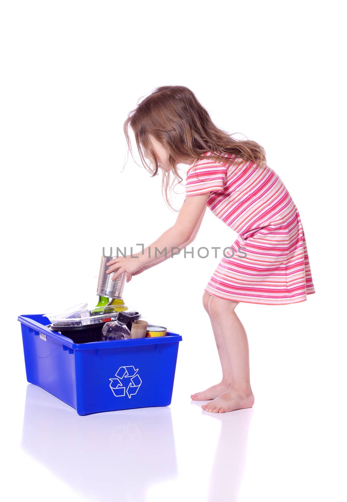 Cute little girl recycling a can