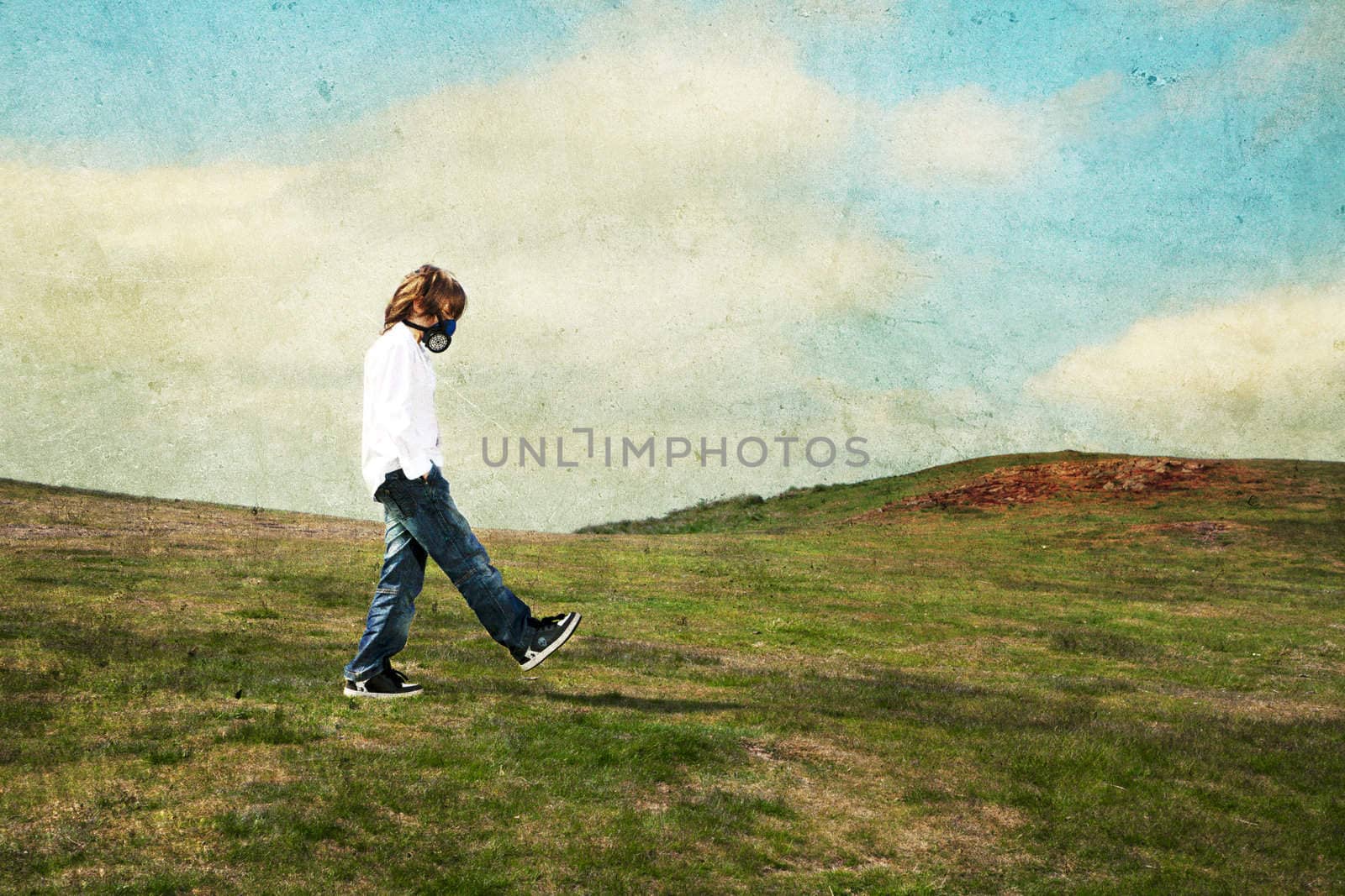 A boy wearing a gas mask walking in the meadow