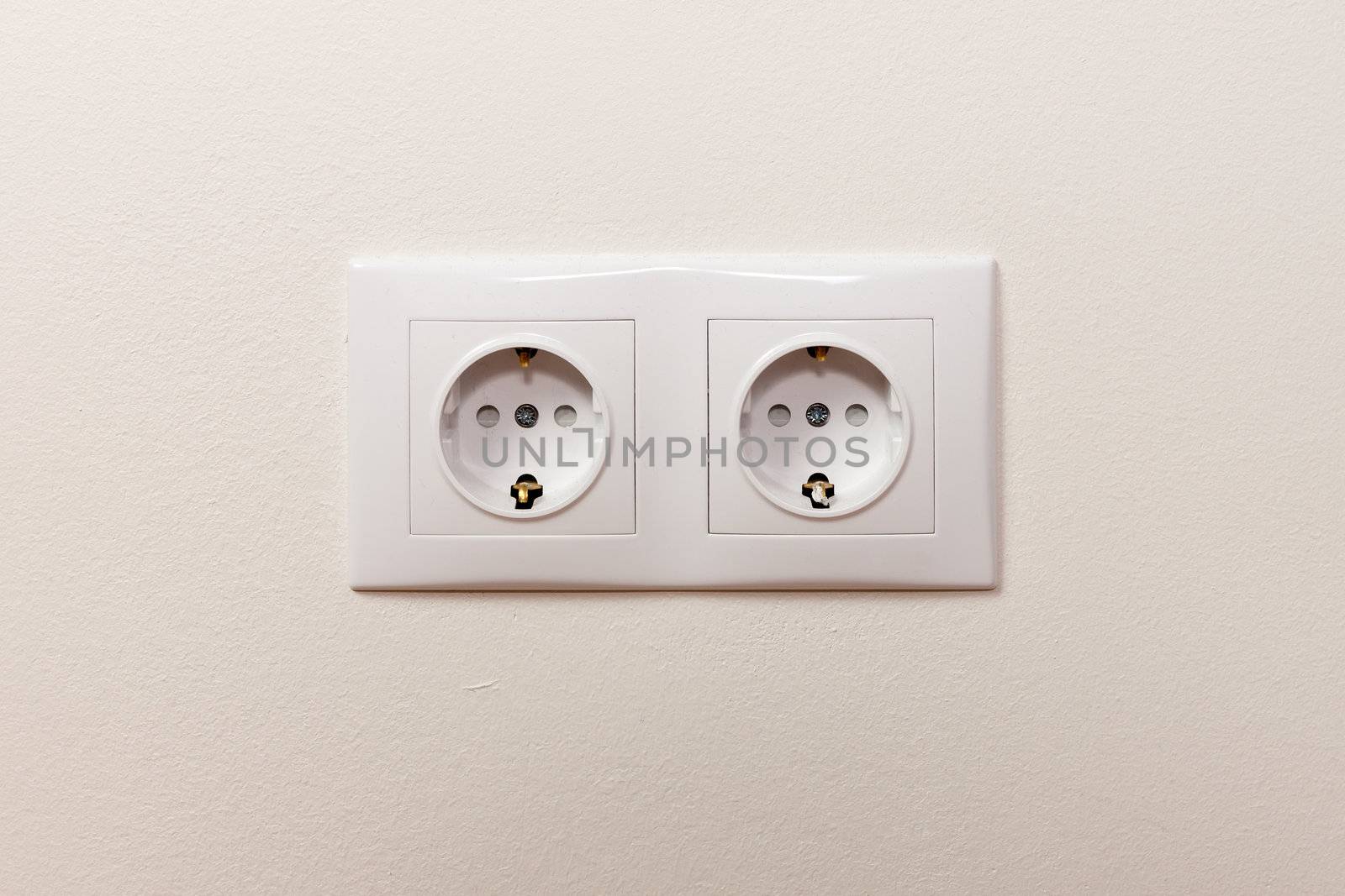 White electric socket on the wall by RTsubin
