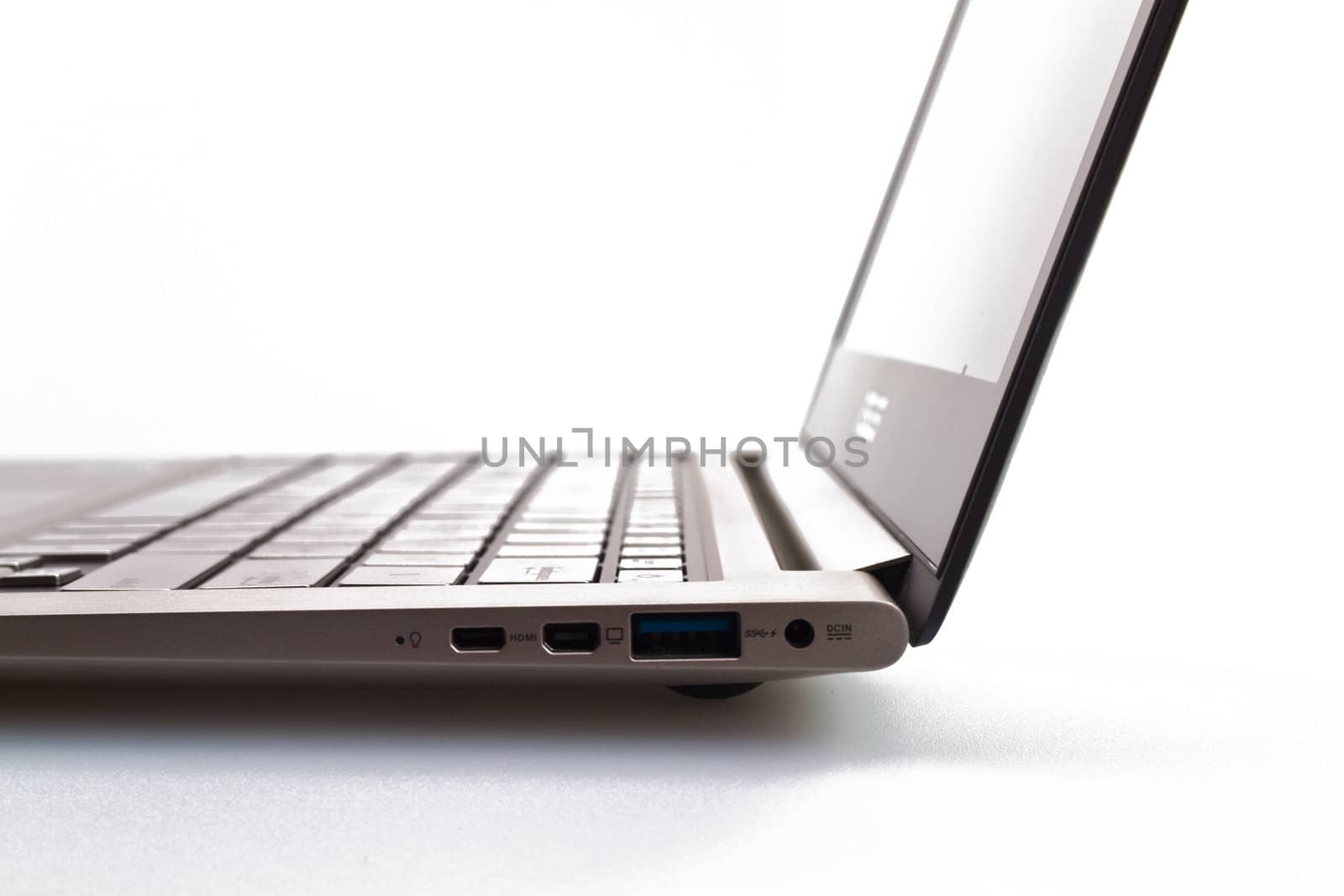 a modern metal laptop with opened lid on white background for abstract background