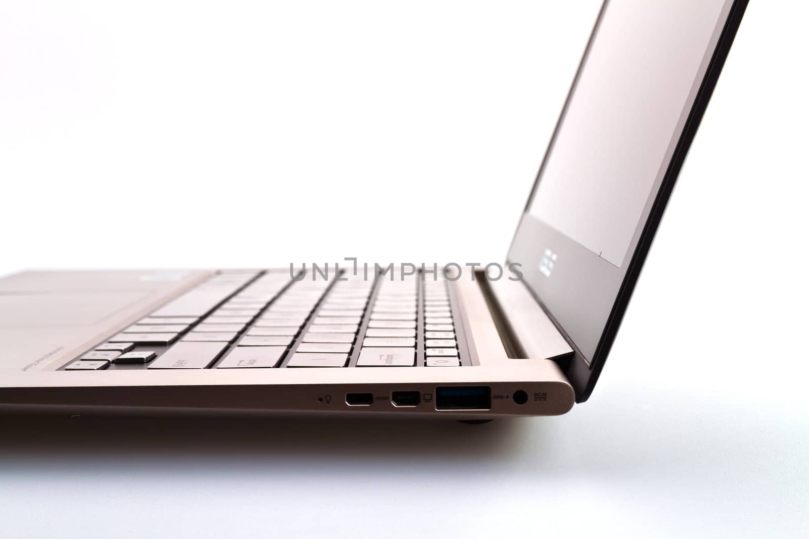 a modern metal laptop with opened lid against white background for abstract background