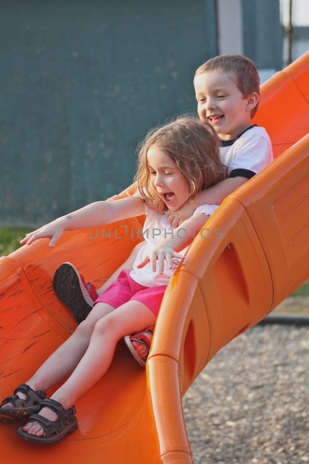 Brother and sister sliding down