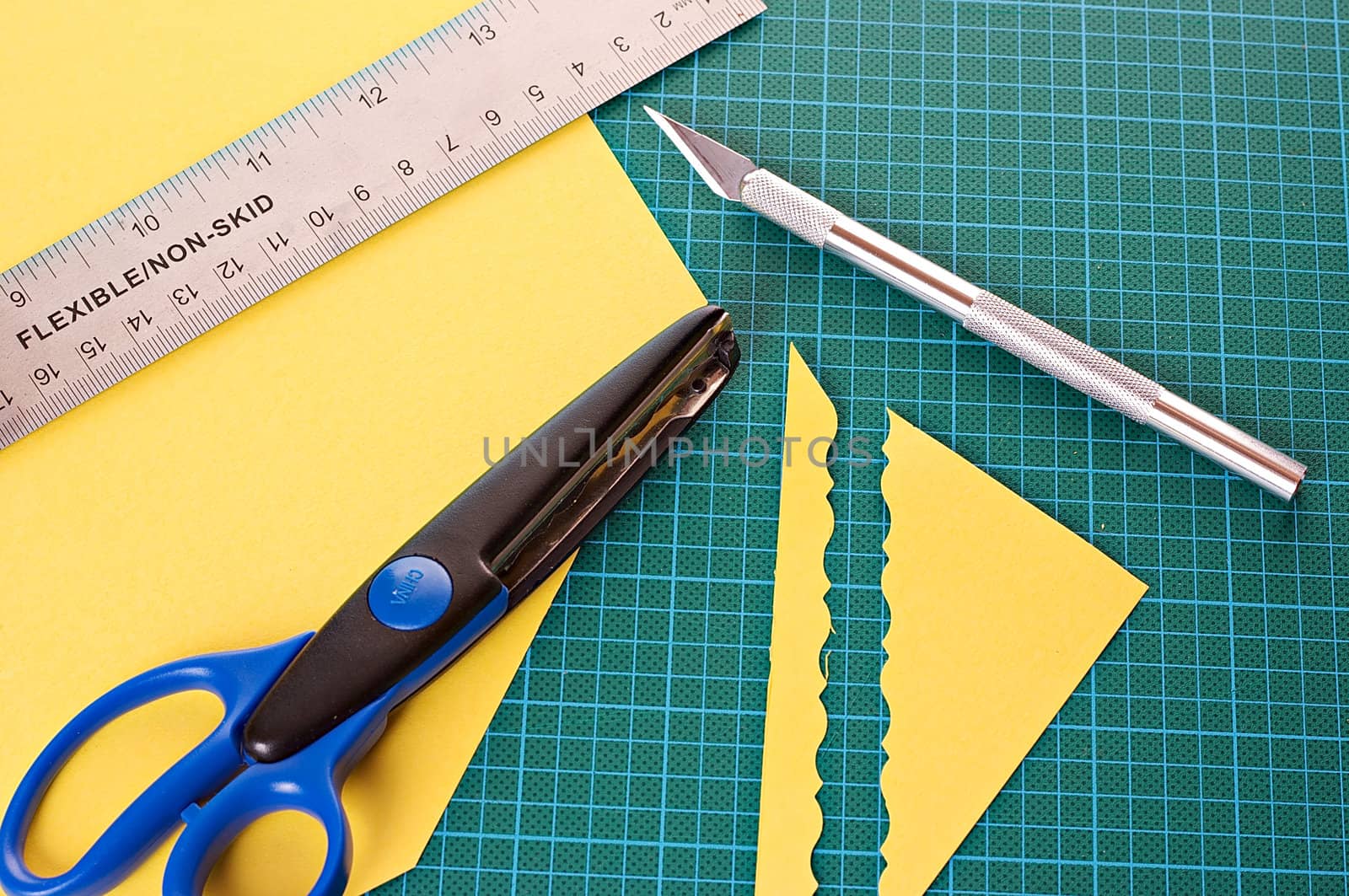 Scrapbooking material: ruler, scissors, mat and knife