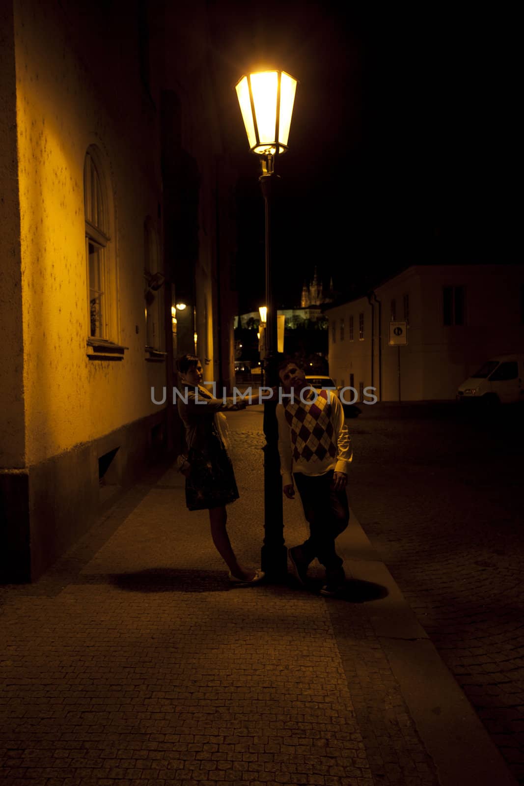 young couple on the streets of Prague nightlife by jannyjus