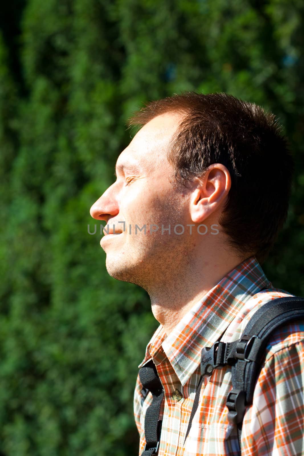 Man on a background of green foliage