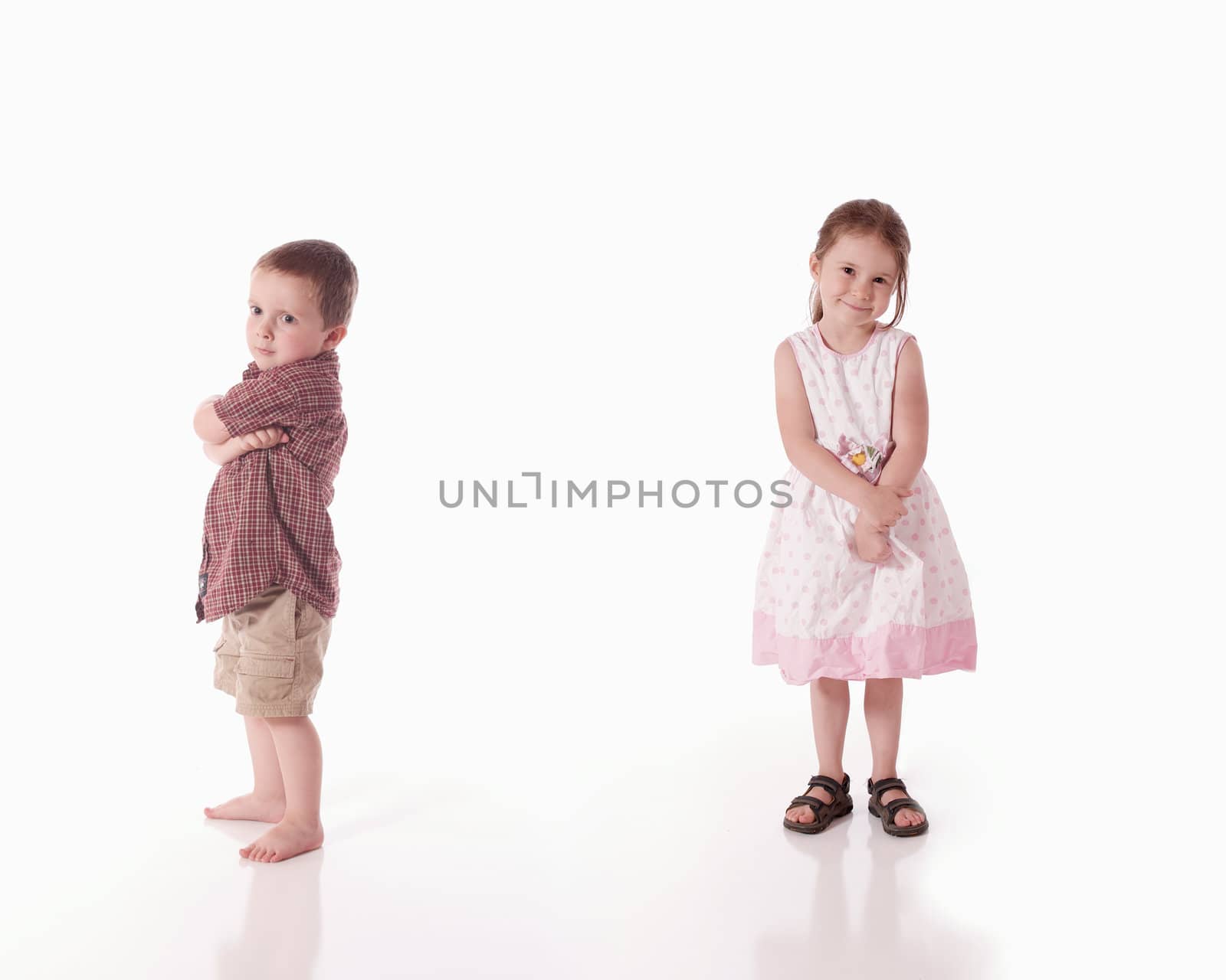 Sulky brother and smiling sister (white background)